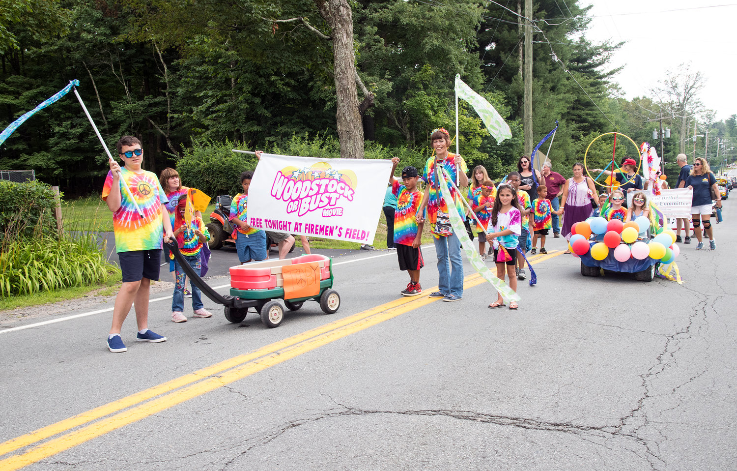 Bethel Parks & Recreation Director, Cathy McFadden and, Tracy Kanyok from the Town’s summer camp, the town’s kids march with banners and a homemade float.